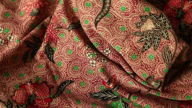 Spinning batik fabric, rotating textured unique pattern background, real time shoot