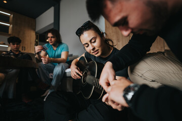 A close-knit group of friends gather together for an intimate guitar session in a cozy indoor...
