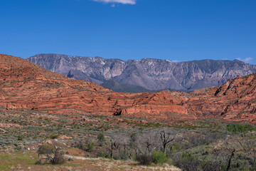 Red Sandstone Cliffs in Southern Utah with the Harmoney Mountains in the distance