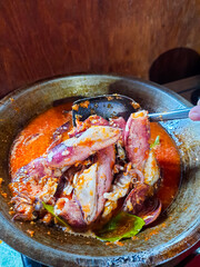 Cumi Balado or red chili squid. one of the typical Minangkabau dishes in Indonesia, fresh squid cooked with spicy chili sauce.