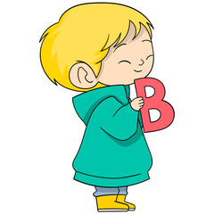 blonde baby boy is standing holding the letter B, learning while playing