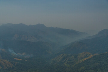 A mountain range with a hazy sky
