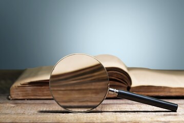 magnifying glass on the page of book, education concept