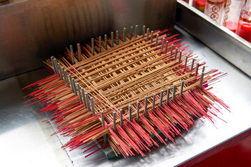 Close-up of neatly arranged incense sticks in a Chinese Buddhist temple