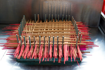 Close-up of neatly arranged incense sticks in a Chinese Buddhist temple