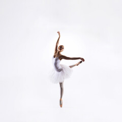 Ballet dancer isolated on white. Beautiful ballerina performing in studio.