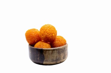 Motichoor Laddu or Motichur Laddoo in a Wooden Bowl Isolated on White Background with Copy Space, Also Known as Bundi Ladoo