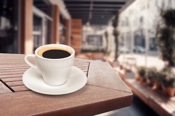 Wooden table at coffee shop  with a cup