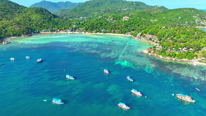 Ship sails amid azure waters as snorkelers explore. A picture-perfect island escape, captured by...