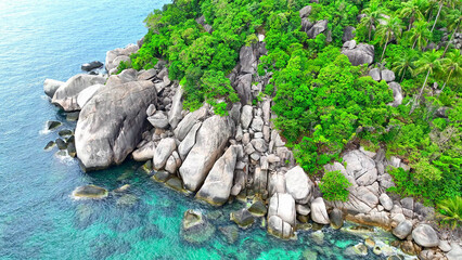Experience the rugged charm of a rocky coastline, embraced by lush green forests and coconut trees,...