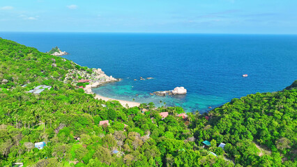 A coastal sanctuary where verdant foliage meets rugged rocks, kissed by azure waves. Serenity...