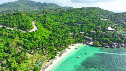 Tranquil sandy shore embraced by lush greenery, adorned with a luxurious resort, cradled by...