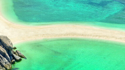 Aerial shot of a curving sandbar between vibrant turquoise waters, showcasing the striking...