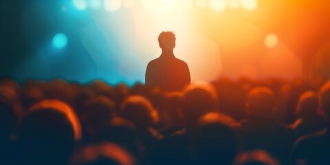 Backlit silhouette of a solitary man standing before a vibrant concert crowd. - obrazy, fototapety, plakaty