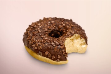 Sweet tasty chocolate donut on pastel background