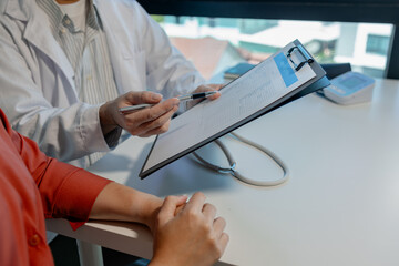 A doctor is explaining blood test results to patient about what diseases were found and what...