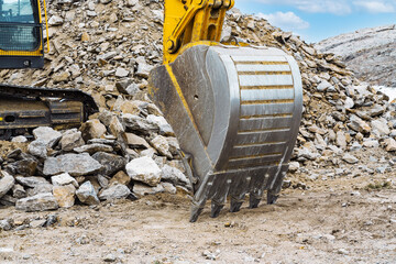 this photo, the excavator bucket is in its original position.