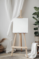 A white background with a wooden easel and a blank canvas on it. The scene depicts an artist's studio with an easel and canvas ready for painting