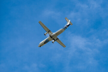 Airplane flying in the sky preparing to land at the airport. Air travel and traveling abroad