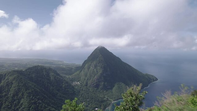 Aerial drone of Petit Piton and Gros Piton.  A UNESCO world heritage site located on the Caribbean island nation of Saint Lucia.  The city of Soufriere can be seen below the peaks of the mountains.