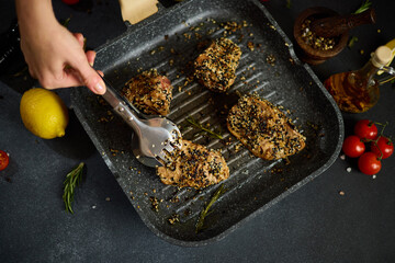 pieces of Organic Tuna fillet covered with sesame seeds frying on a hot grill pan