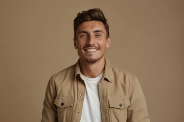 Obraz premium Man in stylish outfit smiling on beige background with space for text