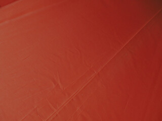 Bright orange umbrella texture for a background about the rainy season or summer.