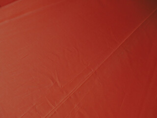 Fototapeta premium Bright orange umbrella texture for a background about the rainy season or summer.