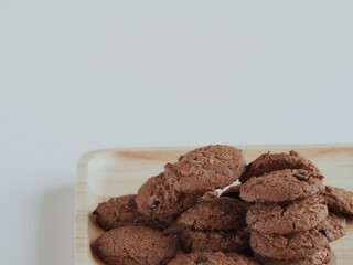 Brown cookies in a wooden tray are delicious for snacks.