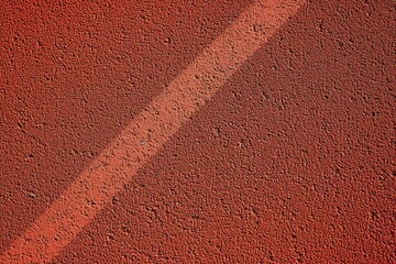 Rubber coated red background used in stadiums tracks and courts Overhead view close up