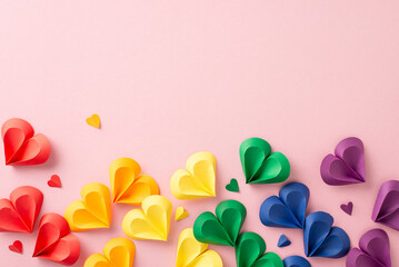 Embrace diversity: Top view colorful hearts on pastel pink, embodying unity and solidarity. Ideal...