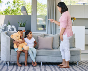 Mother, pointing and scolding child in home, discipline and communication or strict parent in...
