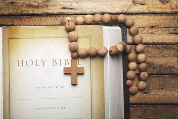 Holly bible book and wooden cross