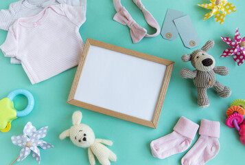 Baby garment and accessories and empty frame mockup.