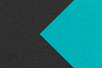 Texture of black paper background, half two colors with turquoise arrow, macro. Craft cerulean...