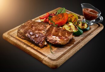 A tasty hot aroma steak meat on a cutting board
