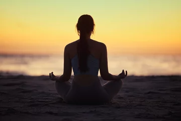  Silhouette, lotus and woman at beach for yoga exercise, meditation or mindfulness in summer at sunset. Back, padmasana and girl at ocean for balance, spiritual peace and calm on mockup space at sea © peopleimages.com