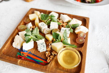 Cheese plate. Gorgonzola, hard cheese, grapes, honey, nuts