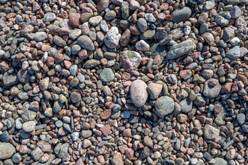 Round granite stones by the sea. Background and texture.