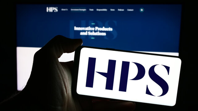 Stuttgart, Germany - 04-13-2024: Person holding mobile phone with logo of American company HPS Investment Partners LLC in front of business web page. Focus on phone display.