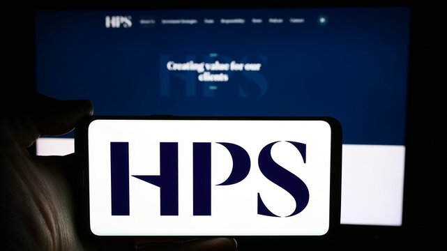 Stuttgart, Germany - 04-13-2024: Person holding cellphone with logo of US company HPS Investment Partners LLC in front of business webpage. Focus on phone display.
