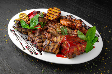 Meat set. A dish of different types of meat: beef steak, pork cuts and ribs, chicken kebab and...