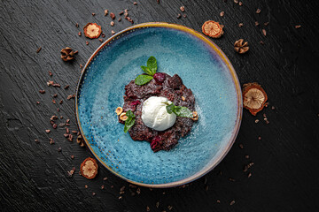 Dessert broken brownies with ice cream. Menu for a pub on a dark background. Colorful juicy food photography.