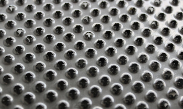 Jagged Edges Of Holes On Steel Puree Grater Surface Textured Background 
