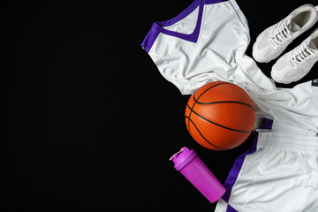 Basketball Gear Prepared for an Evening Training Session on a Dark Backdrop