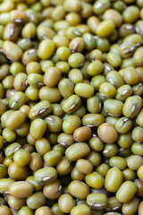 Uncooked, green mung beans background. Dry mung beans grains. Top view. Close-up