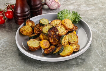 Roasted young zucchini in the plate