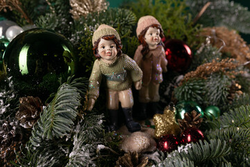 Couple of Figurines Sitting on Top of a Christmas Tree
