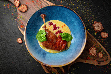 Duck Confit - French slow roasted duck legs. Menu for a pub on a dark background. Colorful juicy food photography.