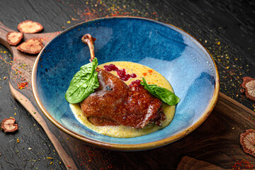 Duck Confit - French slow roasted duck legs. Menu for a pub on a dark background. Colorful juicy...
